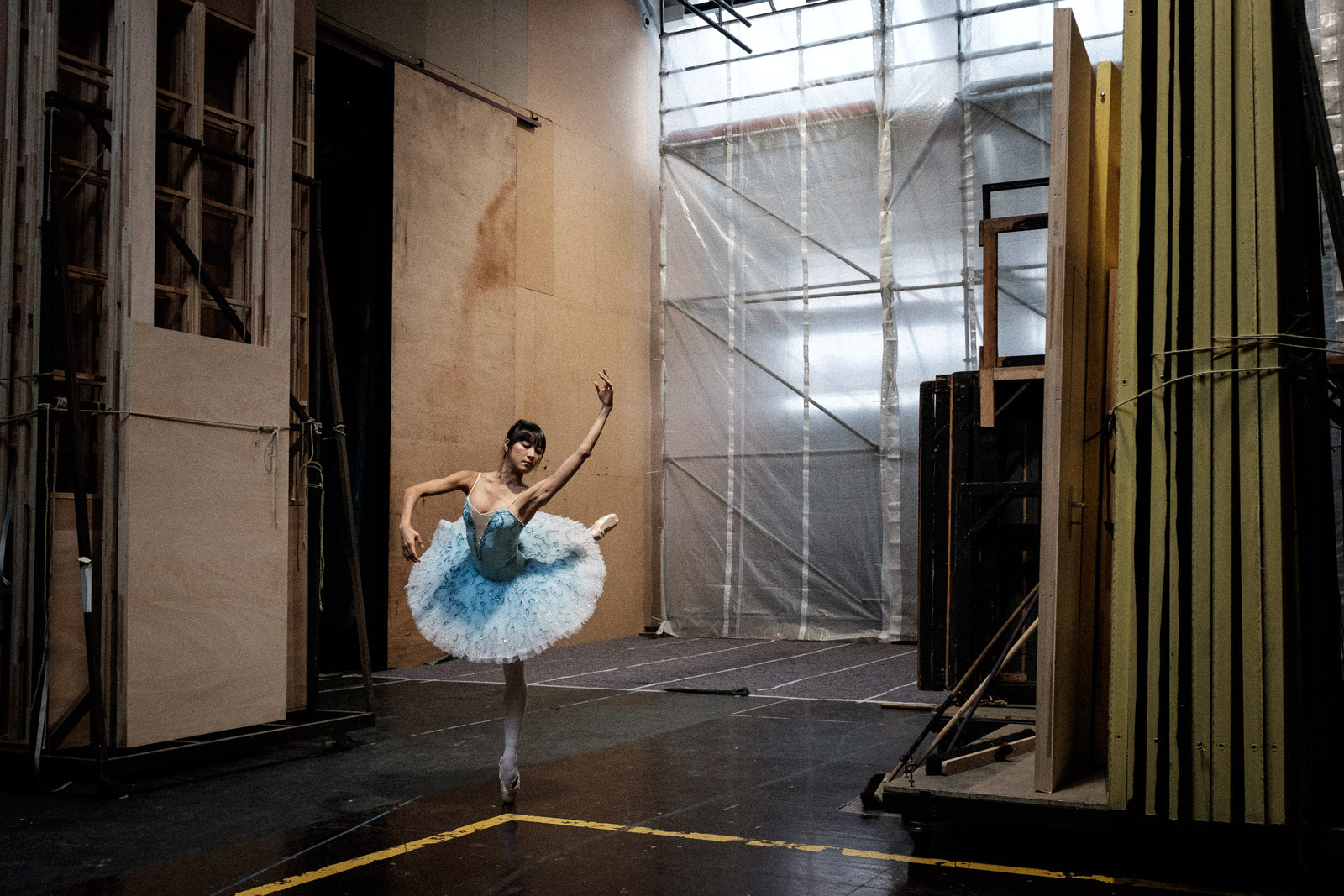 Ballerina warming up backstage with dancing dynamic pose in berlin staatsballett