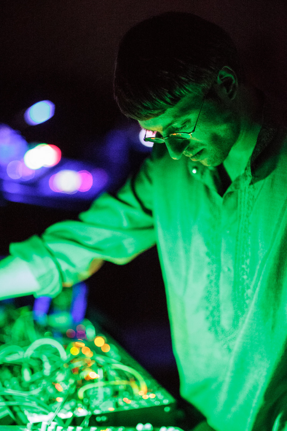 portrait of electronic musician in green light