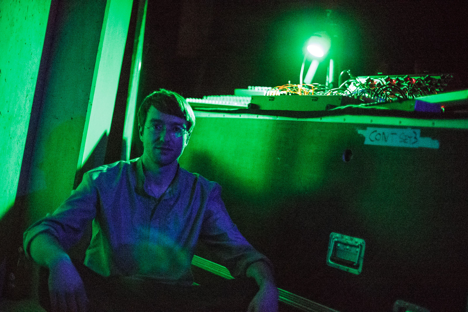 portrait of electronic musician in green and blue light