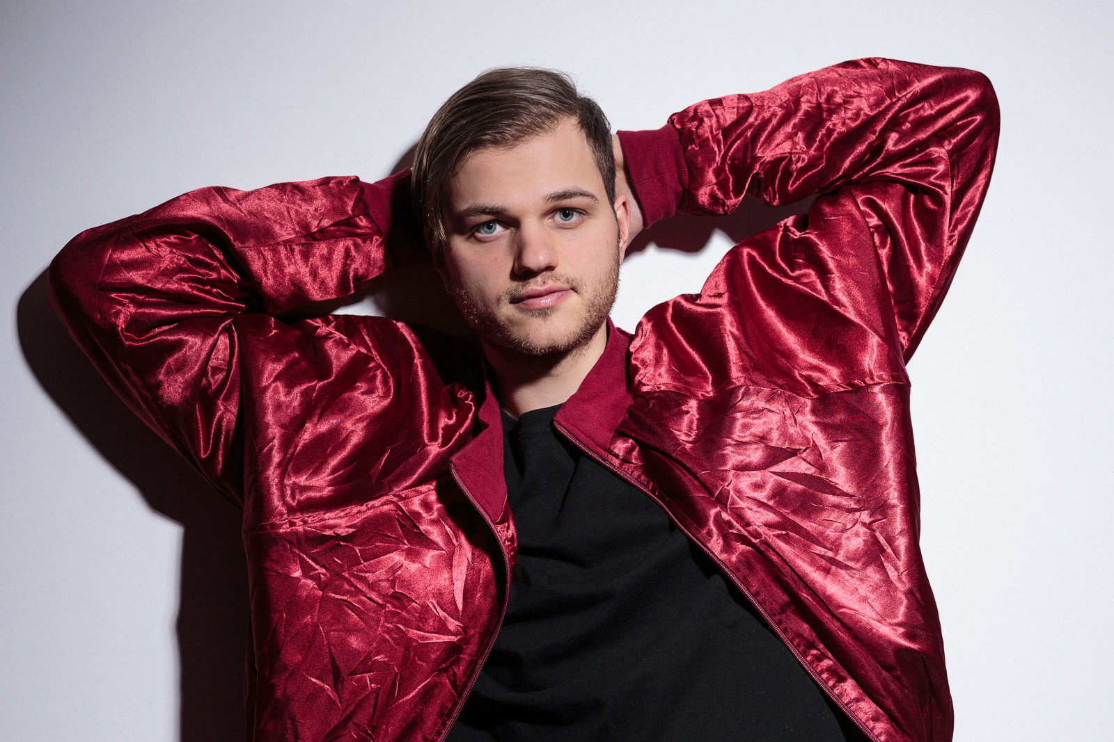 young man wearing shiny red bomber jacket
